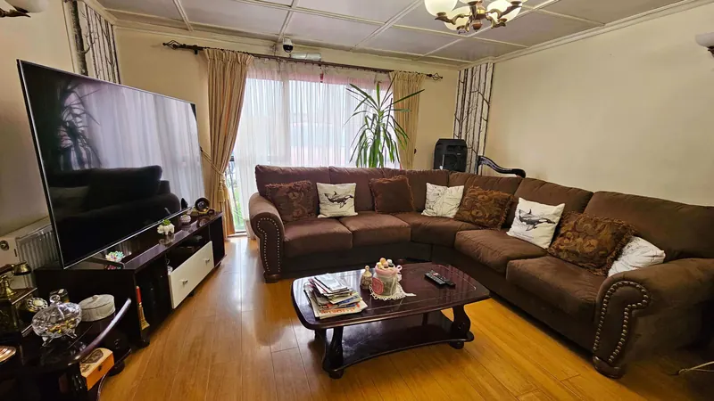 Sala de estar compartida con sofá y TV
